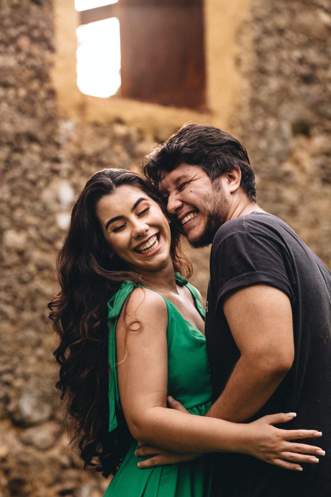Two people smiling in a warm embrace.