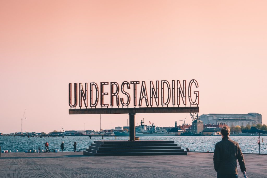 "Understanding" boldly written on a massive Billboard. Understanding and Overcoming Challenges is critical to positive transformation.