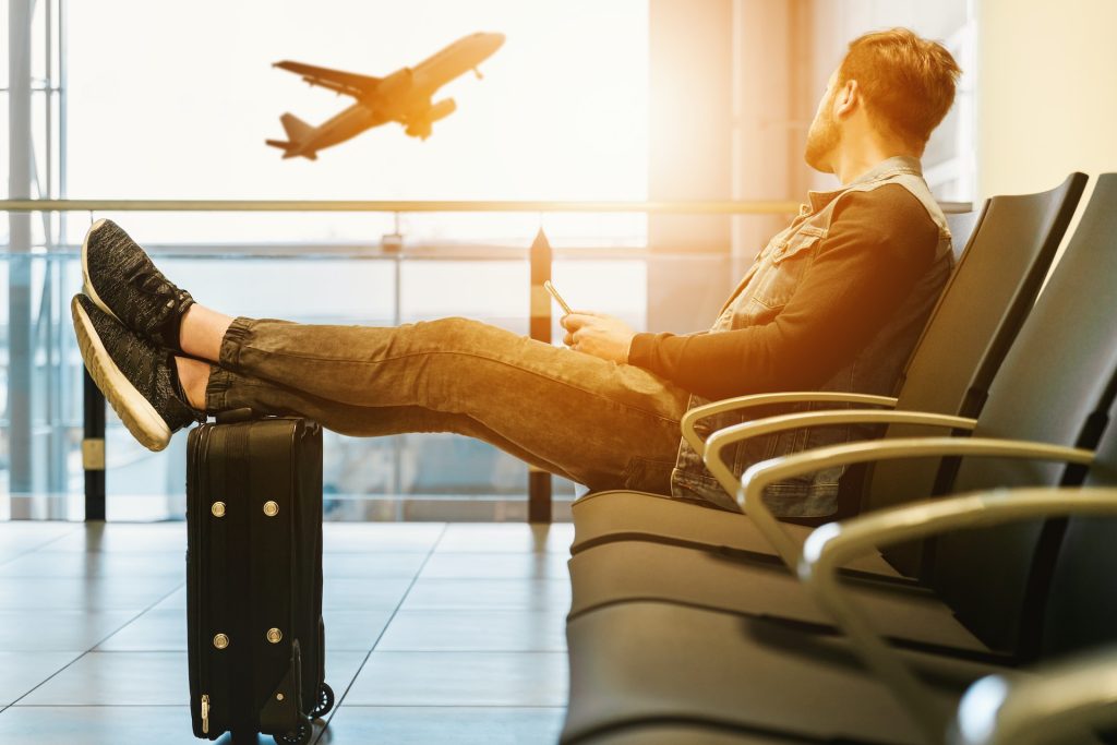 Photo by JESHOOTS.COM on Unsplash. Meaningful travel passenger relaxed in waiting area.