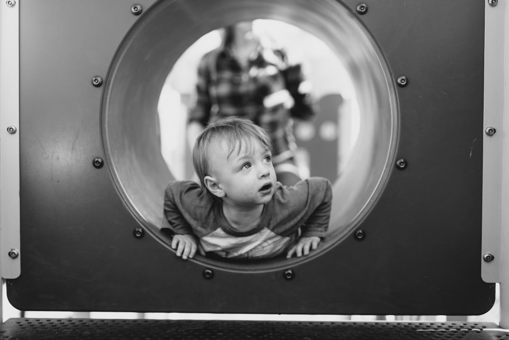 Little child curiously looking out, indicating personal development and transformation as a result of curiosity. photo by Justin Peterson on Unsplash